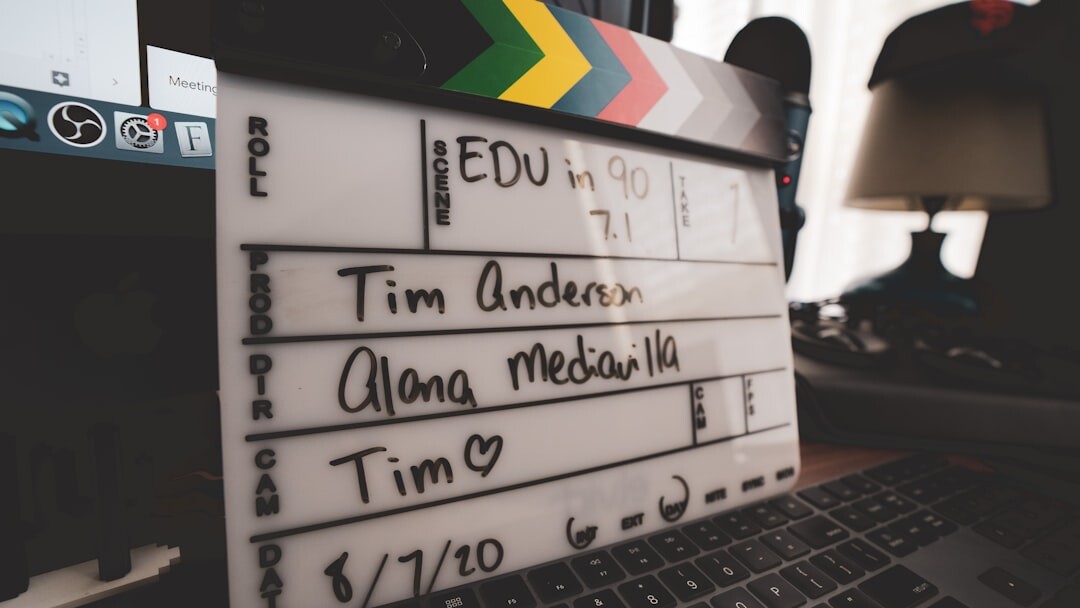 Close up of hands editing video on a laptop timeline